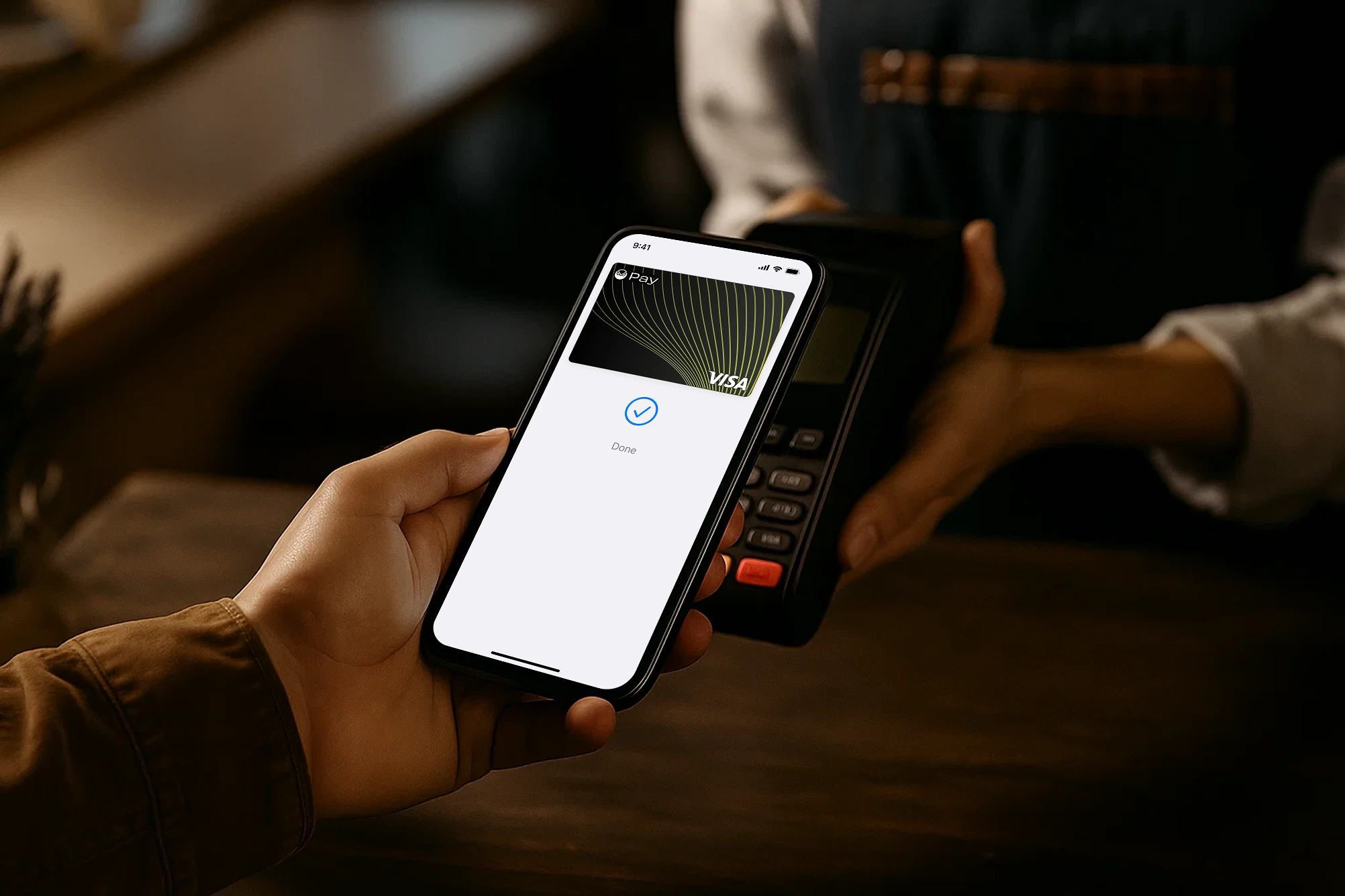 Smartphone confirming a contactless payment with a mobile wallet at a card reader, Zeal Visa card shown on screen.